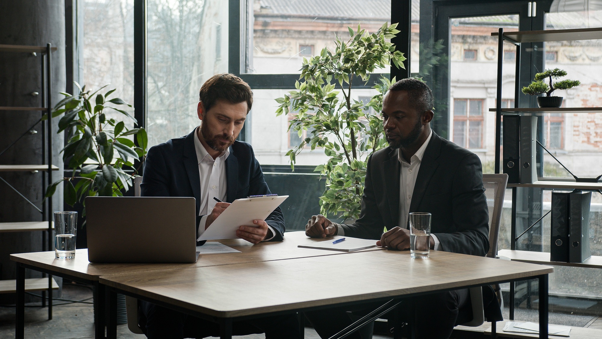 Multiethnic Caucasian and African American business people diverse multiracial men two male partners